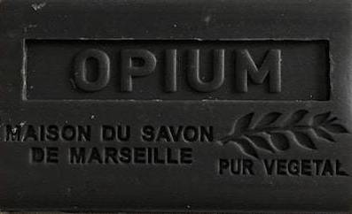 Black soap bar with 'Opium' branding and text on a white background