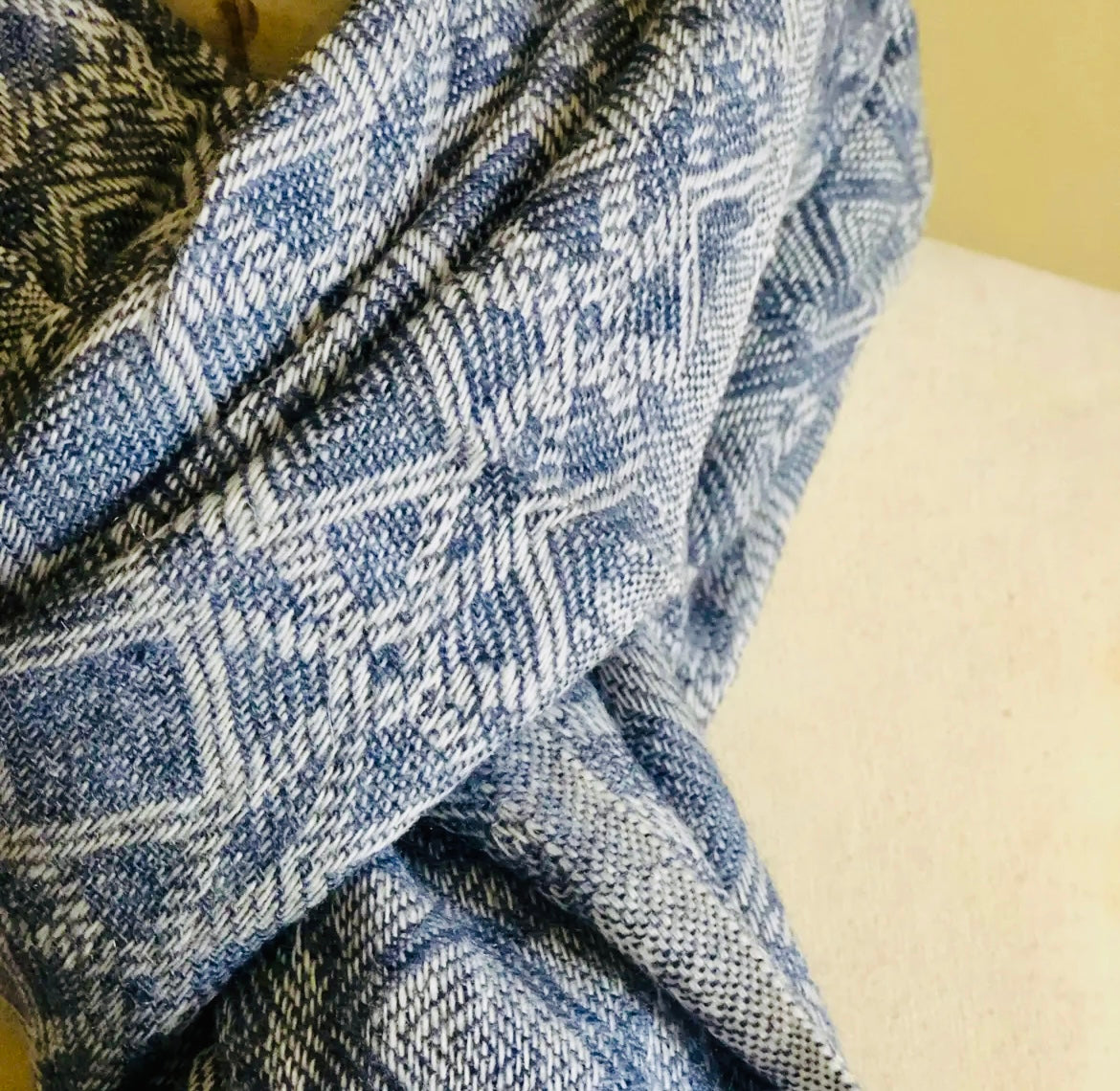 Close-up of a blue and white patterned fabric on a beige surface